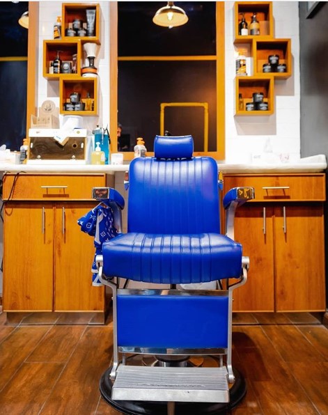 A blue barber chair at MK Barbershop in Dubai